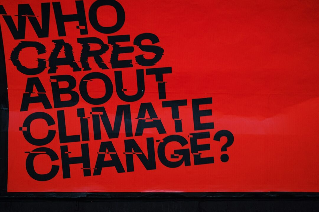 a red sign that says who cares about climate change?